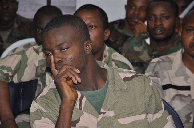In this Thursday, Oct. 2, 2014 file photo, soldiers accused of refusing to fight in the country's northeastern Islamic uprising appear before a court martial in Abuja, Nigeria. On Wednesday Dec. 17, 2014, the court-martial sentenced 54 soldiers to death for mutiny, assault, cowardice and refusing to fight Islamic extremists, connected to the soldiers' refusal to deploy to recapture three towns seized by Nigeria's home-grown Boko Haram in August, according to the charge sheet. . (AP Photo/Olamikan Gbemiga FILE)