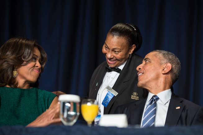 President Barack Obama and First Lady Michelle Obama interact with Hilton banquet server Kitty Casey during the National Prayer Breakfast at the Washington Hilton in Washington, D.C., Feb. 5, 2015. (Official White House Photo by Pete Souza)